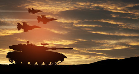Silhouettes of army tank and fight planes on background of sunset. Military machinery. Independence day.の写真素材