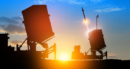Israel's Iron Dome air defense missile launches. The missiles are aimed at the sky at sunset. Missile defense, a system of salvo fire.の写真素材