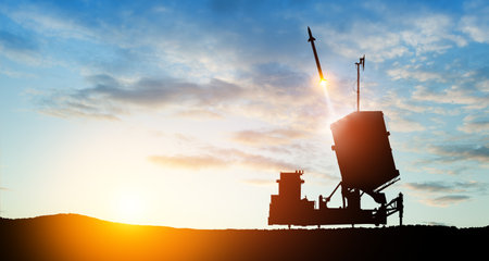 Israel's Iron Dome air defense missile launches. The missiles are aimed at the sky at sunset. Missile defense, a system of salvo fire.の写真素材