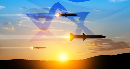 Fired missiles fly to the target. Missiles at the sky at sunset with Israel flag. Missile defense, a system of salvo fire.の写真素材