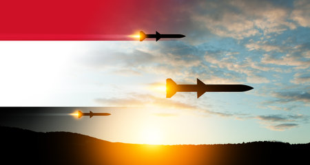 Fired missiles fly to the target. Missiles at the sky at sunset with Yemen flag. Missile defense, a system of salvo fire.の写真素材