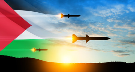 Fired missiles fly to the target. Missiles at the sky at sunset with Palestine flag. Missile defense, a system of salvo fire.の写真素材