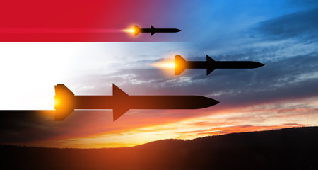 Fired missiles fly to the target. Missiles at the sky at sunset with Yemen flag. Missile defense, a system of salvo fire.の写真素材