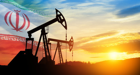 Oil drilling derricks at desert oilfield with Iran flag. The change in oil prices caused by the war. Oil prices are rising because of the global crisis. Crude oil production from the ground.の写真素材