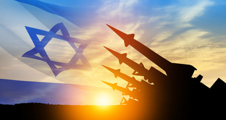 The missiles are aimed at the sky at sunset with Israel flag. Nuclear bomb, chemical weapons, missile defense, a system of salvo fire.の写真素材