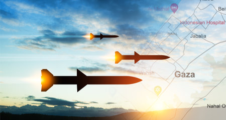 Fired missiles fly to the target. Missiles at the sky at sunset with map of Gaza.の写真素材