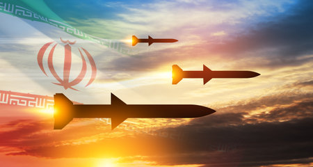 Fired missiles fly to the target. Missiles at the sky at sunset with Iran flag. Missile defense, a system of salvo fire.の写真素材