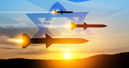 Fired missiles fly to the target. Missiles at the sky at sunset with Israel flag. Missile defense, a system of salvo fire.の写真素材