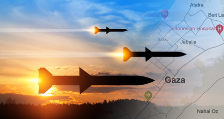 Fired missiles fly to the target. Missiles at the sky at sunset with map of Gaza.の写真素材