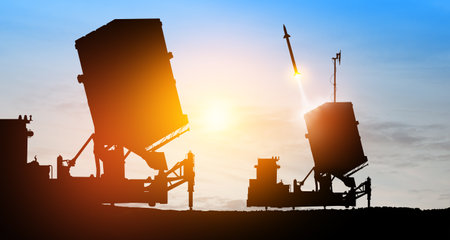 Israel's Iron Dome air defense missile launches. The missiles are aimed at the sky at sunset. Missile defense, a system of salvo fire.の写真素材