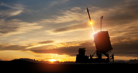 Israel's Iron Dome air defense missile launches. The missiles are aimed at the sky at sunset. Missile defense, a system of salvo fire.の写真素材