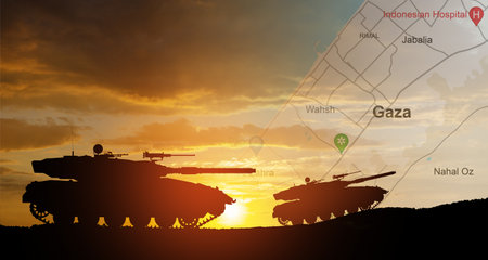 Silhouettes of army tanks at sunset sky background with map of Gaza. Israeli ground operation in Gaza.の写真素材