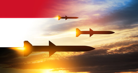 Fired missiles fly to the target. Missiles at the sky at sunset with Yemen flag. Missile defense, a system of salvo fire.の写真素材