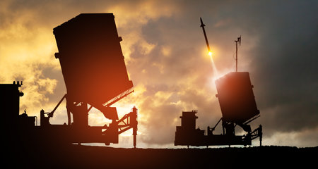 Israel's Iron Dome air defense missile launches. The missiles are aimed at the sky at sunset. Missile defense, a system of salvo fire.の写真素材