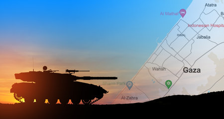Silhouette of army tank at sunset sky background with map of Gaza. Israeli ground operation in Gaza.の写真素材