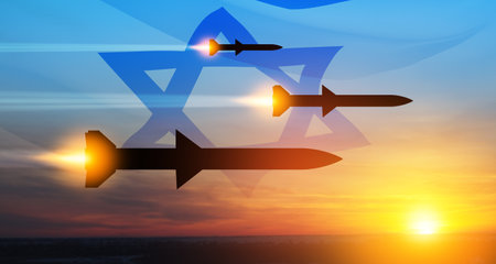 Fired missiles fly to the target. Missiles at the sky at sunset with Israel flag. Missile defense, a system of salvo fire.の写真素材
