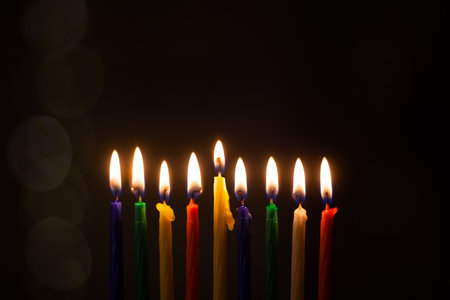 Closeup of Hanukkah menorah, or hanukkiah for Jewish holiday Hanukkah. Nine colored candles. Hanukkah lamp, nine-branched candelabrum.の写真素材
