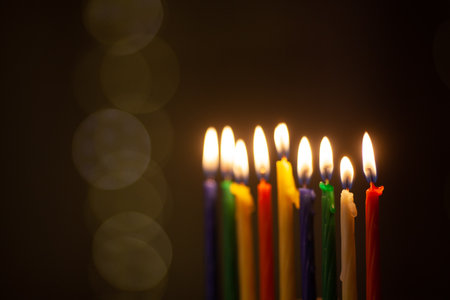 Closeup of Hanukkah menorah, or hanukkiah for Jewish holiday Hanukkah. Nine colored candles. Hanukkah lamp, nine-branched candelabrum.の写真素材