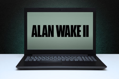 Alan Wake 2 game on laptop screen on black textured wall with green light. Astana, Kazakhstan -...