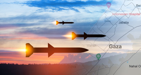 Fired missiles fly to the target. Missiles at the sky at sunset with map of Gaza.の写真素材
