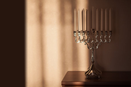 Hanukkah menorah, or hanukkiah in the light of the sun at sunset for Jewish holiday Hanukkah....