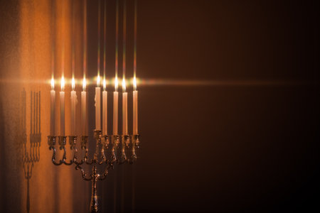 Closeup of Hanukkah menorah, or hanukkiah in the light of the sun at sunset for Jewish holiday Hanukkah. Hanukkah lamp, nine-branched candelabrum with burning candles with star filter.の写真素材