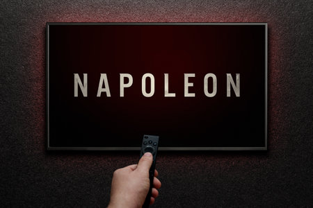 Napoleon trailer or movie on TV screen. Man turns on TV with remote control. Astana, Kazakhstan - July 21, 2023.のeditorial素材