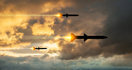 Fired missiles fly to the target. Missiles at the sky at sunset. Missile defense, a system of salvo fire.の写真素材