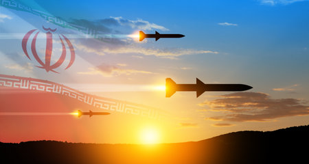 Fired missiles fly to the target. Missiles at the sky at sunset with Iran flag. Missile defense, a system of salvo fire.の写真素材