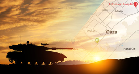 Silhouette of army tank at sunset sky background with map of Gaza. Israeli ground operation in Gaza.の写真素材
