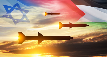 Confrontation between Palestine and Israel. Fired missiles fly to the target. Missiles at the sky at sunset with Palestine flag and Israel flag. Missile defense, a system of salvo fire.の写真素材