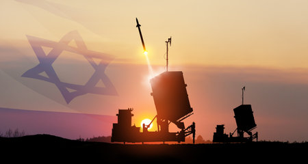 Israel's Iron Dome air defense missile launches. The missiles are aimed at the sky at sunset with Israel flag. Missile defense, a system of salvo fire.の写真素材