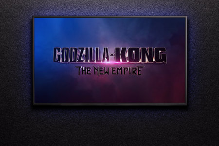 Godzilla x Kong The New Empire trailer or movie on TV screen. TV on black textured wall.のeditorial素材