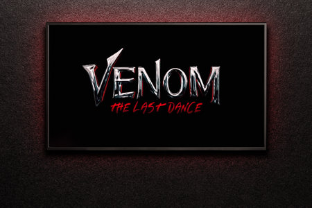 Venom The Last Dance trailer or movie on TV screen. TV on black textured wall.のeditorial素材