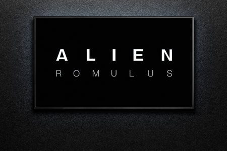 Alien Romulus trailer or movie on TV screen. TV on black textured wall. Astana, Kazakhstan - July 31, 2024.のeditorial素材