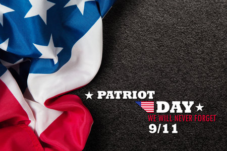 Patriot Day We Will Never Forget inscription inscription with USA flag on black textured background....