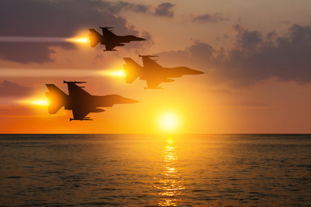 Aircraft silhouettes on background of sunset.