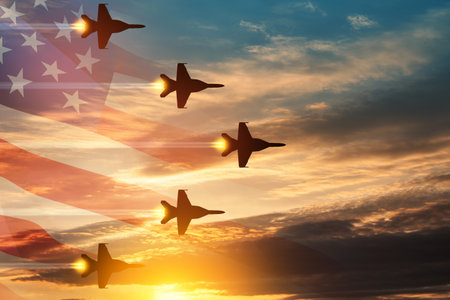 Aircraft silhouettes on background of sunset with a transparent American flag.の写真素材