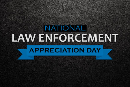Law enforcement appreciation day is observed every year on January 9. Inscription on black textured background with transparent American flag.の写真素材