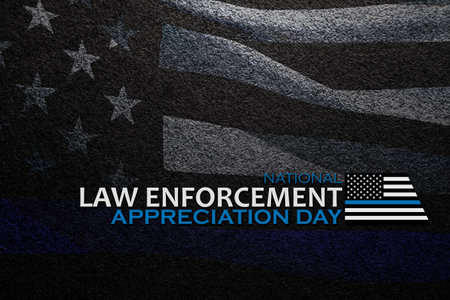 Law enforcement appreciation day is observed every year on January 9. Inscription on black textured background with transparent American flag.の写真素材