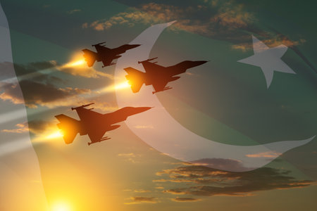 Air Force Day. Aircraft silhouettes on background of sunset with a transparent Pakistan flag.の写真素材