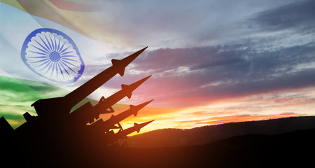 The missiles are aimed at the sky at sunset with Indian flag.