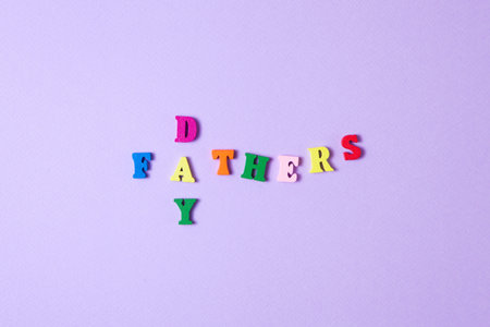 Childs toy letters spelling Fathers Day on purple backgroundの写真素材