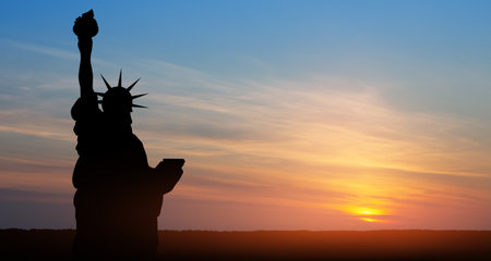 Statue of Liberty on background of sunset sky.の写真素材