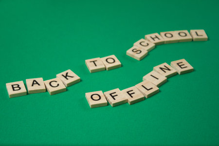 Back to School Offline Text by wooden letters on a green background. Distance learning conceptの写真素材