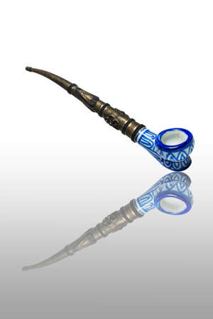 antique precious pipe with reflection isolated on white backgroundの写真素材