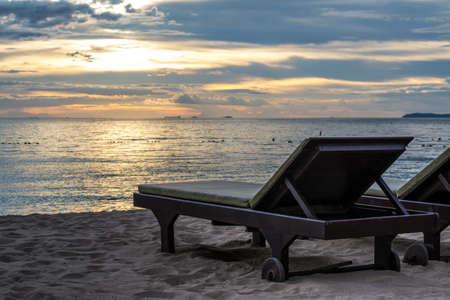 beautiful beach chair in sunset sceneの写真素材