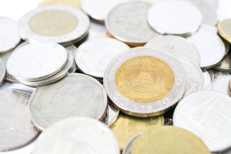 pile of Thai bath coins on white backgroundの写真素材