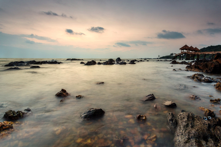 A Long exposure picture of golden sunrise with stone jettyの写真素材
