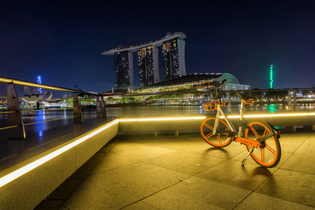 Marina Bay, Singapore - April 1 2018 : A  bicycle operated by obike are parking with view of Marina Bay Sand. oBike is first stationless smart bike share system in Singaporeのeditorial素材